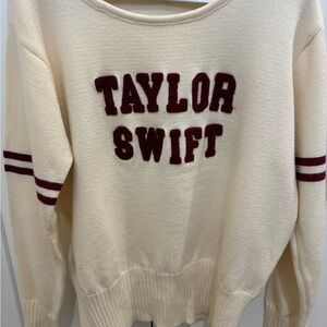 Taylor Swift Cream Sweater with Burgundy Logo and Sleeve Stripes